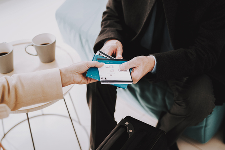 Couple with Tickets in Airport in Waiting Room. Senior Person in Airport. Tourism Concept. Airport Terminal. Vacation for Pensioner. People with Baggage. Travelers on Vacation.の写真素材