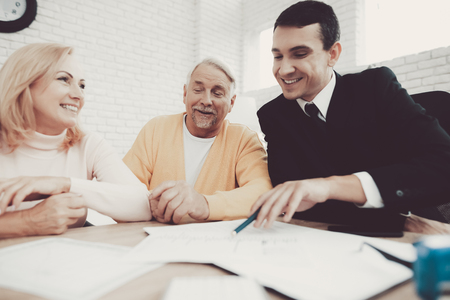 Old Man and Woman Visiting Young Lawyer in Office. Important Documents. Modern Law Office. Grandfather and Grandmother. People with Gray Hair. Young Advocate. Justice and Law Concepts.の写真素材