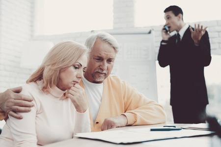 Old Man and Woman Visiting Young Lawyer in Office. Important Documents. Modern Law Office. Grandfather and Grandmother. People with Gray Hair. Young Advocate. Justice and Law Concepts.の写真素材