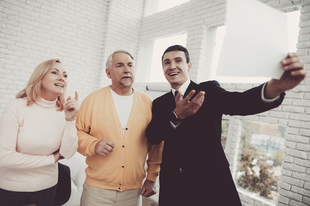 Old Man and Woman Visiting Young Lawyer in Office. Important Documents. Modern Law Office....