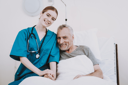 Stethoscope Help Patient. Nurse with Patient. Nurse Help Patient in Clinic. Rehabilitation in Clinic. Aged Patient Happy with Nurse. Mature Patient and Young Nurse. Concept in Hospital. Sick Patient.の写真素材