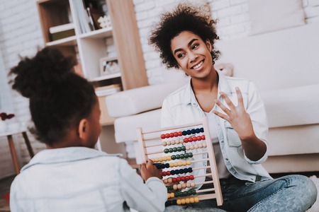 Mother Help Daughter with Study. Happy Girl and Happy Mother. Smart Girl and Happy Mother Study. People Study in Studio Together. Creative Time For Girl. Fun Girl and Happy Time Together. Smile Time.の写真素材