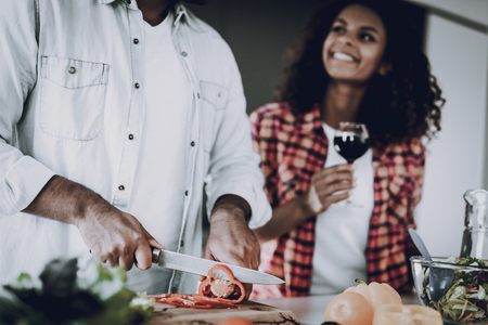 Afro American Happy Couple Cooking At Kitchen. Weekend Concept. Holiday Resting. Smiling Together. Having Fun. Cheerful Sweethearts. Time To Breakfast. Healthy Lifestyle. Wine Drinking.の写真素材