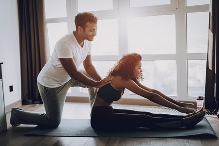 Afro American Couple. Morning Exercises Concept. Gym Carpets. Work Out Together. Healthy Lifestyle. Shape Sportswear. Attractive Athlete. Physical Healthcare. Help Each Other. Spine Massage.の写真素材