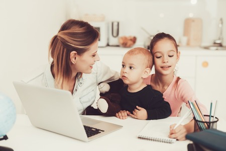 Mom And Daughter Are Playing With Little Baby. Family Relationship Concept. Gadget Screen. Taping On Keyboard. Little Hands. Active Family. Holiday Leisure. Happy Childhood. Parent's Duty.の写真素材