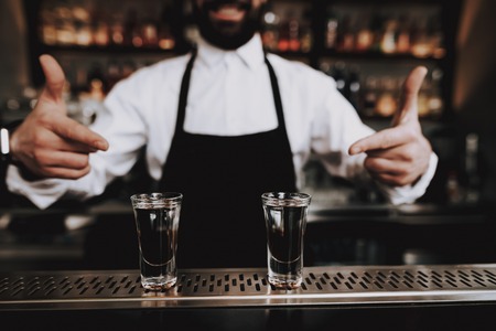 Leisure Time. Barman with Beard. Prepared Cocktail. Bar. Group of Young People. Rest. Drink Alcoholic Beverages. Have Fun. Together. Joyful. Chin-chin. Nightlife. Positive. Emotion. Clubbing. Guys.の写真素材