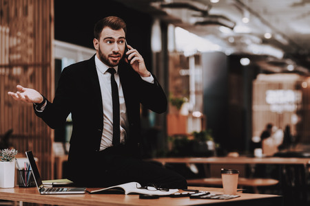 Talking Loudly on Phone. Business Suit. Workplace. Ideas. Project. Laptop. Sit. Brainstorm. Young...