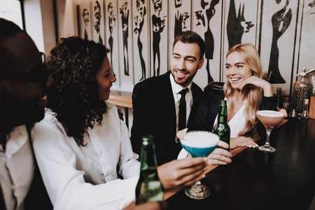 Rest. Drink Alcoholic Beverages. Girls and Guys. Different Races Communicate. Bar. Young People. Have Fun. Together. Clubbing. Nightlife. Cocktails. Joyful. Chin-chin. Leisure. Positive. Emotion.の写真素材