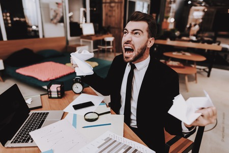 Brainstorm. Upset. Large Amount of Work. Business Suit. Workplace. Ideas. Project. Laptop. Sit. Young Guy. Businessman. Work. Office. Creative Businesspeople. Inspiration. Comfortable Office.の写真素材