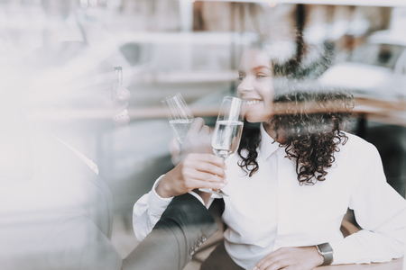 Drinking Champagne. Kiss. Black Man. Date. Girl. In Love. Smile. Mulatto. Rest. Cafe. Window. Have Fun. Food to Customers'. Joyful. Chin-chin. Leisure Time. Nightlife. Positive. Emotion. Clubbing.の写真素材