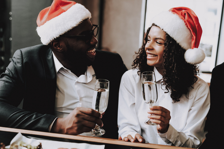 Santa's Hat. Young People. Rest. Emotion. Girls and Guys. Drink Alcoholic Beverages. Different Races Communicate. Bar. Have Fun. Together. Clubbing. Nightlife. Joyful. Chin-chin. Leisure. Positive.の写真素材
