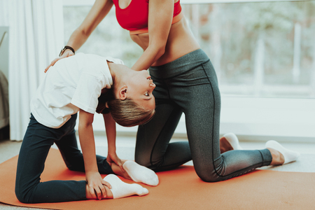 Mum And Daughter Training Stretch. Heel Touch. Yoga Concept. Beauty And Grace. Active Lifestyle. Relaxing Together. Doing Fitness At Home. Holiday Leisure. Body Balance. Sport Exercise.の写真素材