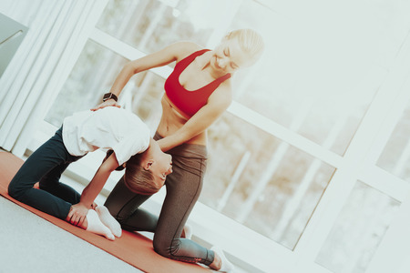 Mum And Daughter Training Stretch. Heel Touch. Yoga Concept. Beauty And Grace. Active Lifestyle. Relaxing Together. Doing Fitness At Home. Holiday Leisure. Body Balance. Sport Exercise.の写真素材