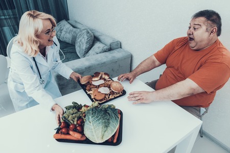 Doctor in White Coat Offers Vegetables to Fat Man. Man with Bulimia. Unhealthy Lifestyle Concept....