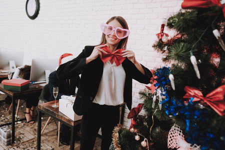 Young Woman in Glasses Decorating Christmas Tree.の写真素材