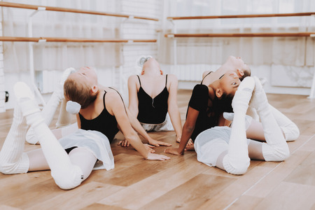 Ballet Training of Group of Young Girls on Floor. Classical Ballet. Girl in Balerina Tutu. Training...