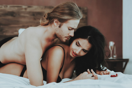 Undressed Man Kisses Woman. Person in Black Underwear. White Linens. Woman with Man Topless. Girl in...