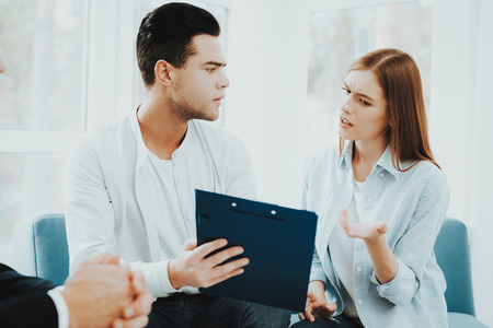 Young Couple. Meeting With Rieltor Concept. Bright Office. Making A Contract. Buying A Property. Panoramic Windows. Business Meeting. Customer And Buyer. Offer Discussion. Professional Agreement.の写真素材