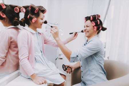 Little Girl with Curlers. Beautiful Little Lady. Girl in Beauty Salon. Girl with Brush in Hands. Consept Beauty Salon. Beautiful Little Lady. Service Consept. Play with Brushes. Girl and Woman.の写真素材