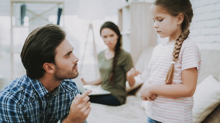 Father Scolds Daughter. Family Problems. Scared Child. Complicated Relationship. Family Quarrel. Bad Parents. Sufferings Children. Man Screams Girl. Woman Arguing with Man. Woman Working on Laptop.の写真素材