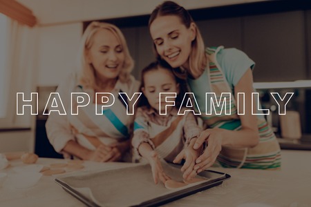 Dough Circles. Happy Family. Girl. Baking Sheet. Together at Home. Thanksgiving Day. Home-Made. Aprons. Woman. Grandmother. Have Fan. Recipes. Smile. Kitchen. Celebrating Holiday. Biscuit.の写真素材