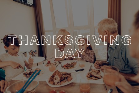 Traditional Dinner. Have Fan. Family. Cups of Tea. Holiday. Blue Shirt. Baked Turkey. Happy Family. Thanksgiving Day. Together at Home. Autumn Feast. Celebrating Holiday. Delicious Food.の写真素材