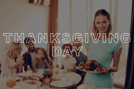 Traditional Dinner. Baked Chicken. Woman. Happy Family. Salad. Holiday. Thanksgiving Day. Family. Dinner Table. Plate. Blue Shirt. Have Fan. Together at Home. Celebrating Holiday. Delicious Food.の写真素材