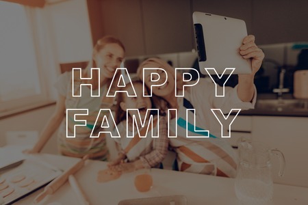 Do Selfie. Close Up. Woman. Elderly. Girl. White. Smartphone. Kitchen. Make a Cookies. Happy Family. Have Fan. Together at Home. New Technology. Thanksgiving Day. Autumn Feast. Celebrating Holiday.の写真素材