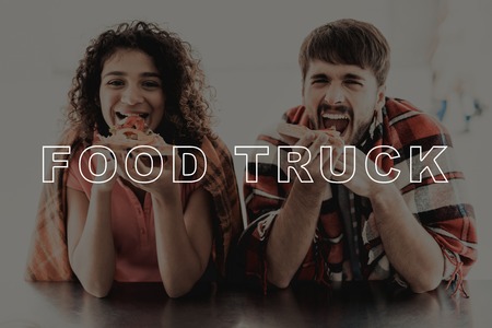 Young Couple Wrapped In Plaids. Food Truck Eating. Making An Order For Two. Young And Beautiful. Stylish Teenagers. Cold Day. Having Dinner Together. Pizza Time. Hungry Sweethearts.の写真素材