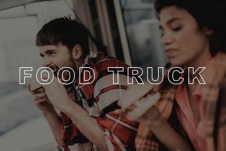 Young Couple Wrapped In Plaids. Food Truck Eating. Making An Order For Two. Young And Beautiful. Stylish Teenagers. Cold Day. Having Dinner Together. Pizza Time. Hungry Sweethearts.の写真素材