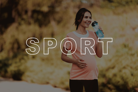 Pregnant woman walking in the parkの写真素材