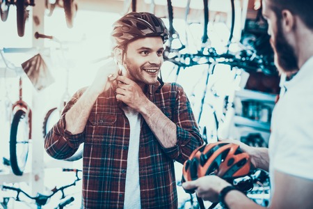 Consultant Helps Guy Choose Helmet for Bike Rides.の写真素材