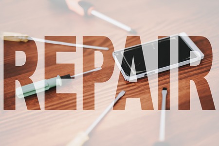 Broken Mobile Phone and Screwdrivers Set.の写真素材