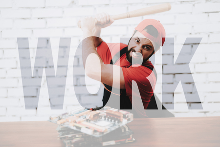 Angry Worker Destroys PC Motherboards with Baseball Bat.の写真素材