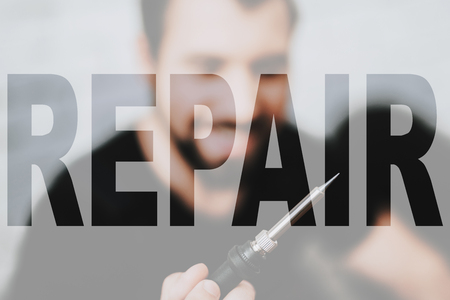 Technician Master Holds Soldering Iron.の写真素材