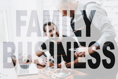Happy Old Father Teaches Son. Technician Teaches to Fix Broken Device. Family Business in Computer Service. Technician Maintenance. Technology Electronic. Young Repairman Fixes Technical Problem.の写真素材