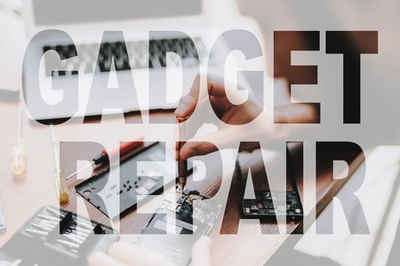 Electronic Engineer Disassembles Mobile Phone. Parts and Microchips of the Device. Smartphone Repair. Hands with Computer Screwdrivers Set. Concept of Professional Gadget Repair. Electronic Repair.の写真素材