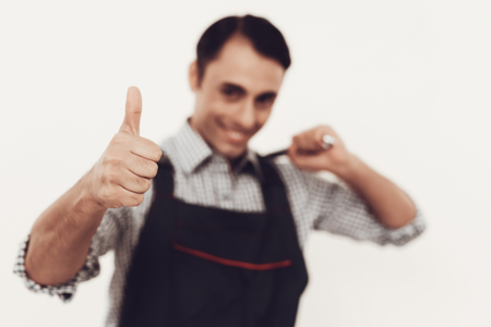 Master in Blue Uniform. Man with Work Tools. Arab Master on White Background. Cheerful Worker. Smiling Master. Service Worker. Master Arabic Nationality. Tools in Hand. Profession Constructor.の写真素材