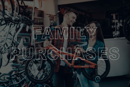 Family Purchases. Customers Choosing a Bicycle for Himself. Customers is Couple of Man and Woman....