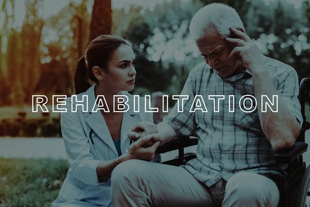 Outdoor Rehabilitation. Doctor Holding Man Hand. Sick Old Man. Disabled in Wheelchair. Good Medicine...