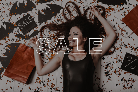 Young Woman Surrounded Confetti. Dark Hair Sexy Vampire. Smiling Glamour Lady. Halloween Sale. Lady...