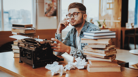 Concept of Young Guy Working on Typewriter. Handsome Hardworking Freelance Screenwriter Scenarist...