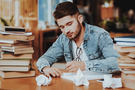 Concept of Young Text Writer Working Indoors. Handsome Hardworking Screenwriter Scenarist Sitting at...