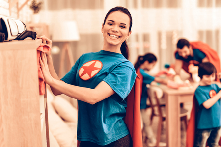 Superhero Mother Cleaning House with Family. Mother with Kids Washing at Home. Cleaning Day Concept. Kids Helping House Chores. Parent Concept. Domestic Concept. Superhero Costumes.の写真素材