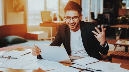 Smiling Happy Businessman Look at Laptop Screen. Portrait of Confident Successful Freelancer in...