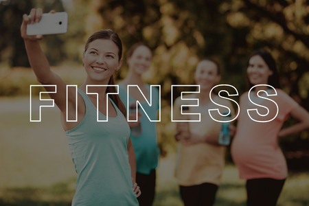 Girls make Selfie on Smartphone. Smiling Pregnant in Park. Girls with Sports Bottle. Three Pregnant in Sportswear. Fitness for Belly Outdoors. Bodycare Crossfit. Healthy Lifestyle. Exercise on Nature.の写真素材