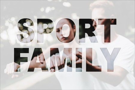 Sport Family in Park. Guy Helps Female. Man Trainer Daughter. Woman Standing on Yoga Rug.の写真素材