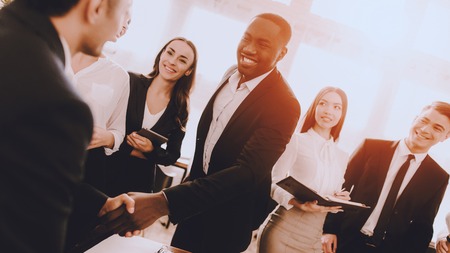 Team of Managers Have Conversation in Office. Meeting in Office. Modern Office Concept. Cooperation with Colleagues. Businessman with Team. Team Building on Workplace. Businessman in Suit.の写真素材