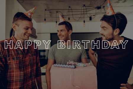 Happy Birthday Celebration. Guys Happy Together. Best Friend Forever. Birthday Boy with Giftbox. Men in Birthday Hat. Friends Prepare Surprise Party. Men Having Fun. Guys Spend Time Together.の写真素材