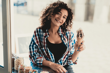 Woman in Shirt Buying Ice Cream in Food Truck. Promenade in Town. Summer Day. Girl in Checkered Shirt. Street Food Concept. Cup of Coffee. Buying Food Outdoor. Food in Town. Selling Snacks.の写真素材